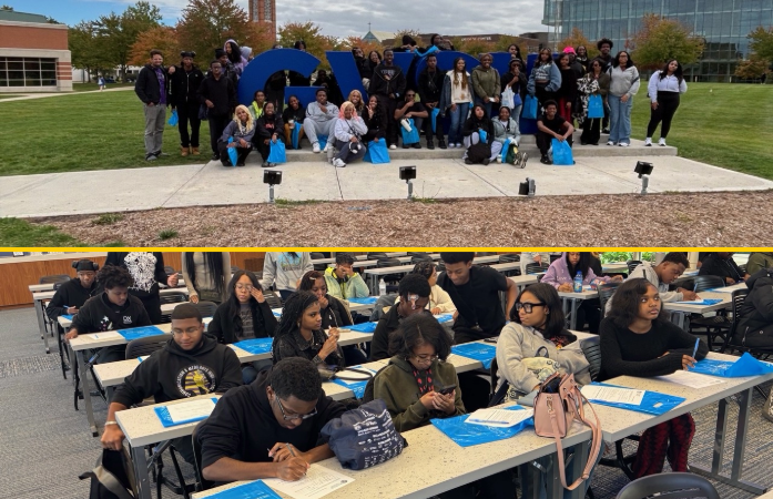 Students standing in front of GVSU sign